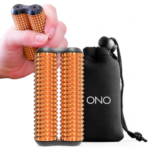 A metallic copper or rose-gold handheld fidget roller standing upright next to its matching black drawstring storage pouch, which features the word "ONO" printed in white. In the upper-left corner, a hand demonstrates how the device is held, showing the two parallel cylindrical rollers covered in dozens of small, pointed acupressure pyramids designed for tactile sensory feedback.