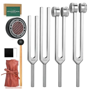 A collection of silver metal tuning forks and sound healing accessories arranged against a clean white background. Four tuning forks of varying lengths stand vertically, engraved from left to right with frequencies "384Hz", "256Hz", "136.1Hz", and "128Hz", with the latter two featuring weighted circular tips. To the left, accessories are stacked vertically: a small cardboard box labeled "Path to Natural Healing," a round black rubber tuning fork activator with a geometric pattern, a wooden mallet with a black rubber ball head, a black microfiber cleaning cloth, and a brown drawstring storage pouch tied with a matching ribbon.